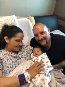 parents holding newborn