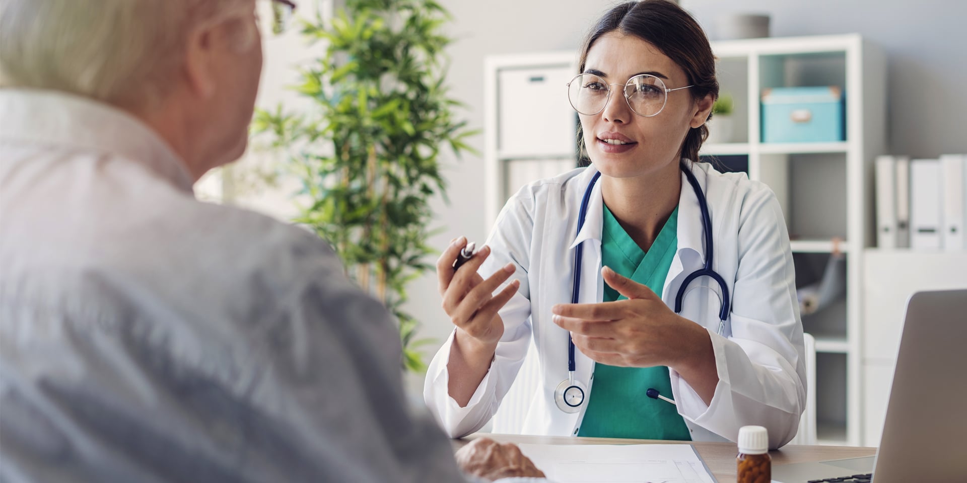 female doctor at desk talking to a man